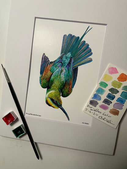 Giclee print of a painted bunting perched on a floral teacup displayed in a white mat.
