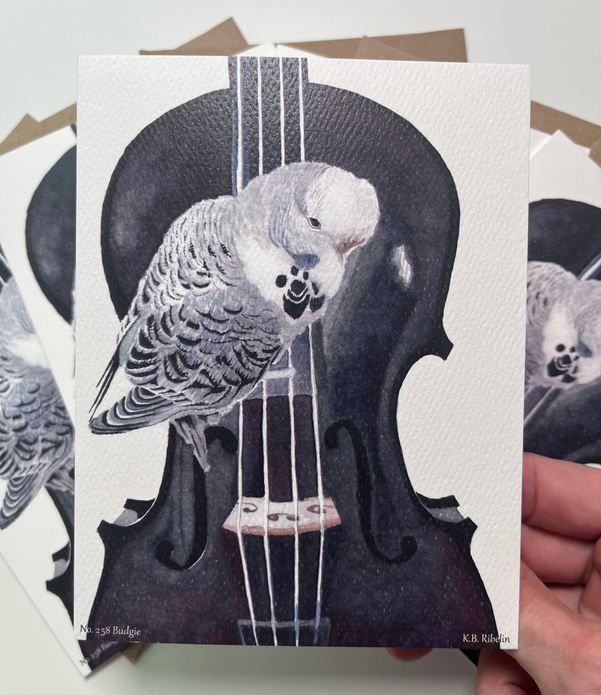 Single notecard printed with the blue‑green budgie perched on a violin watercolor painting.