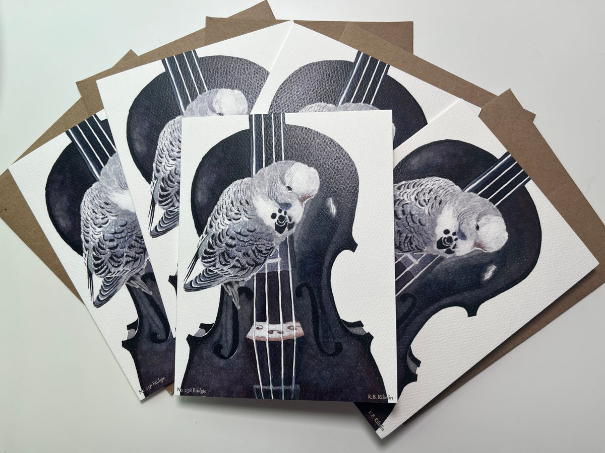 Notecard set featuring the blue‑green budgie perched on a violin watercolor artwork.