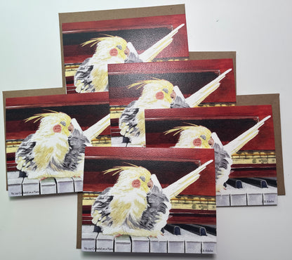 Notecard set featuring the cockatiel perched on a piano artwork.
