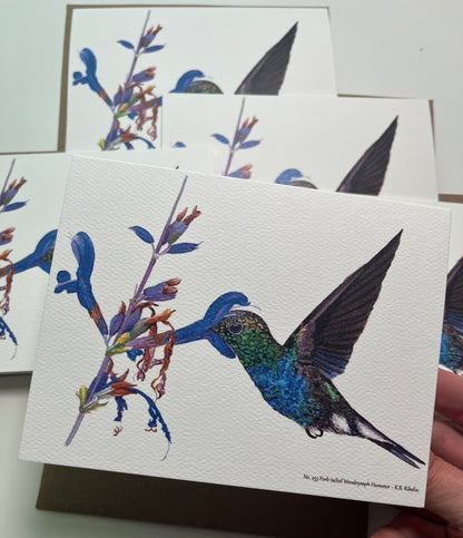 Single notecard printed with the the fork‑tailed wood nymph hummingbird feeding from a tropical flower watercolor painting.