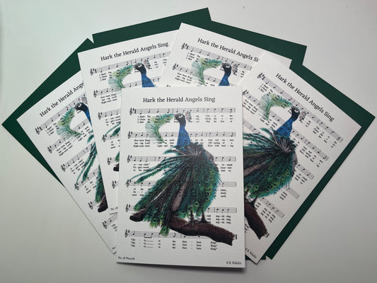 Christmas 2026 notecard set featuring Hark the Herald Angels Sing with festive peacock artwork by KB.