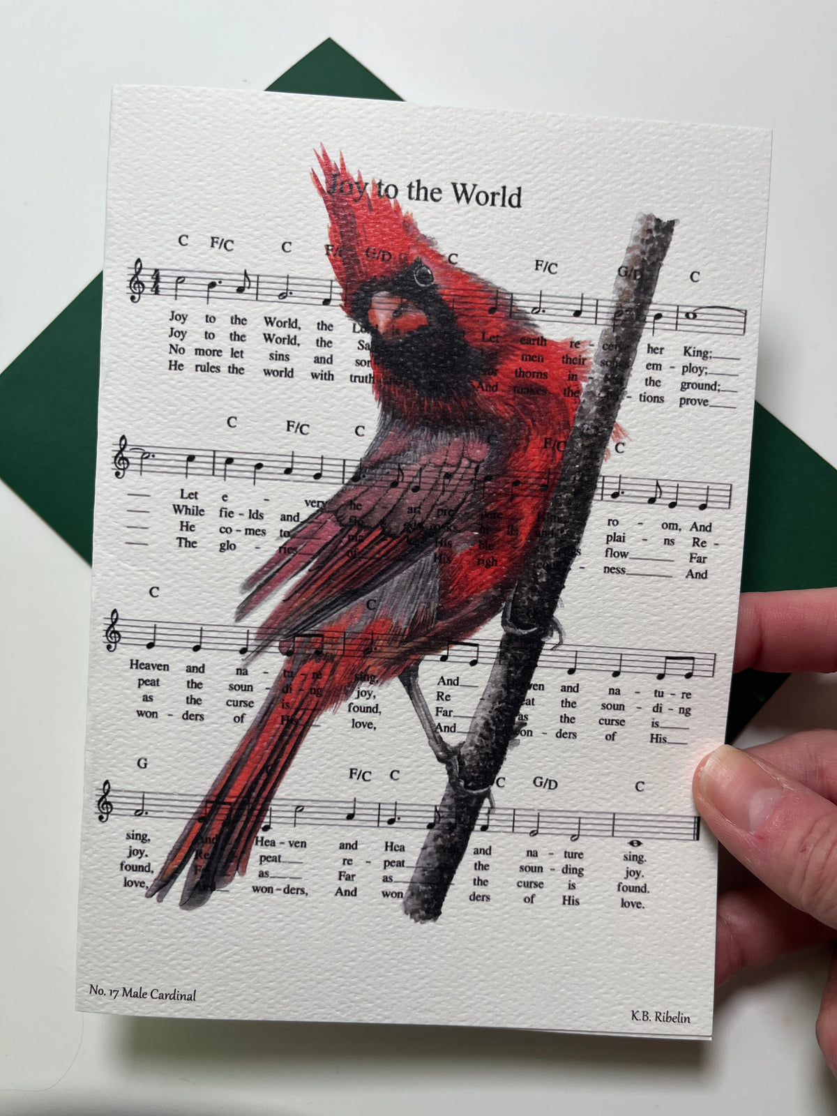 Christmas 2026 notecard featuring Joy to the World with male cardinal artwork by KB.