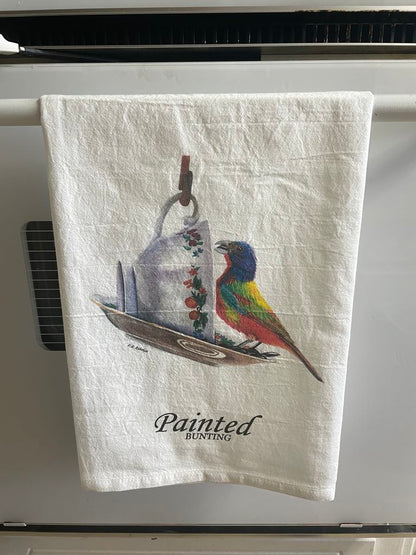 Tea towel printed with the painted bunting on a floral teacup artwork.